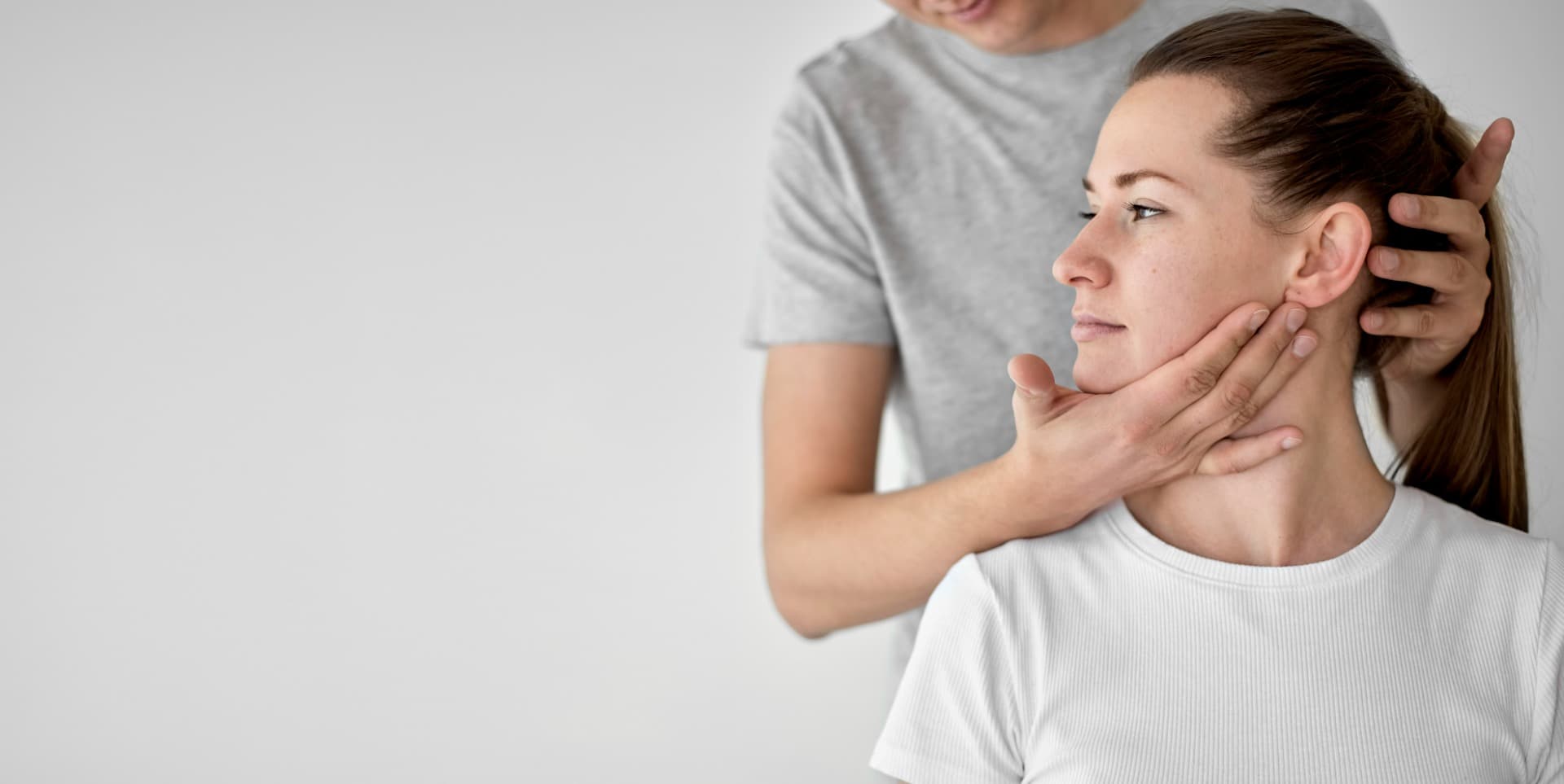Physiotherapist providing hands-on neck assessment